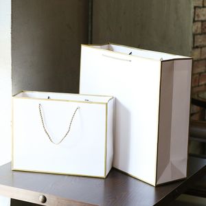 Low MOQ white paper gift bag For Clothing Shopping luxury paper Bag With your own logo Ribbon Handle for packaging