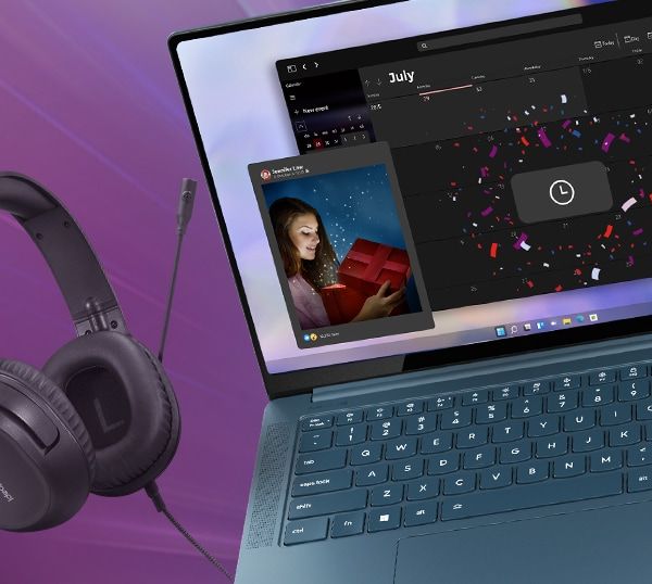 Yoga Laptop with IdeaPad headphones next to it and a Lenovo Mouse and tablet