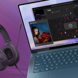 Yoga Laptop with IdeaPad headphones next to it and a Lenovo Mouse and tablet