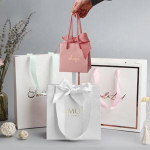 Yiwu Custom Matt Lamination Luxury White Paper Shopping Bag Small Rose Gold Foil Logo Jewelry Gift Bags With Ribbon Bow Tie